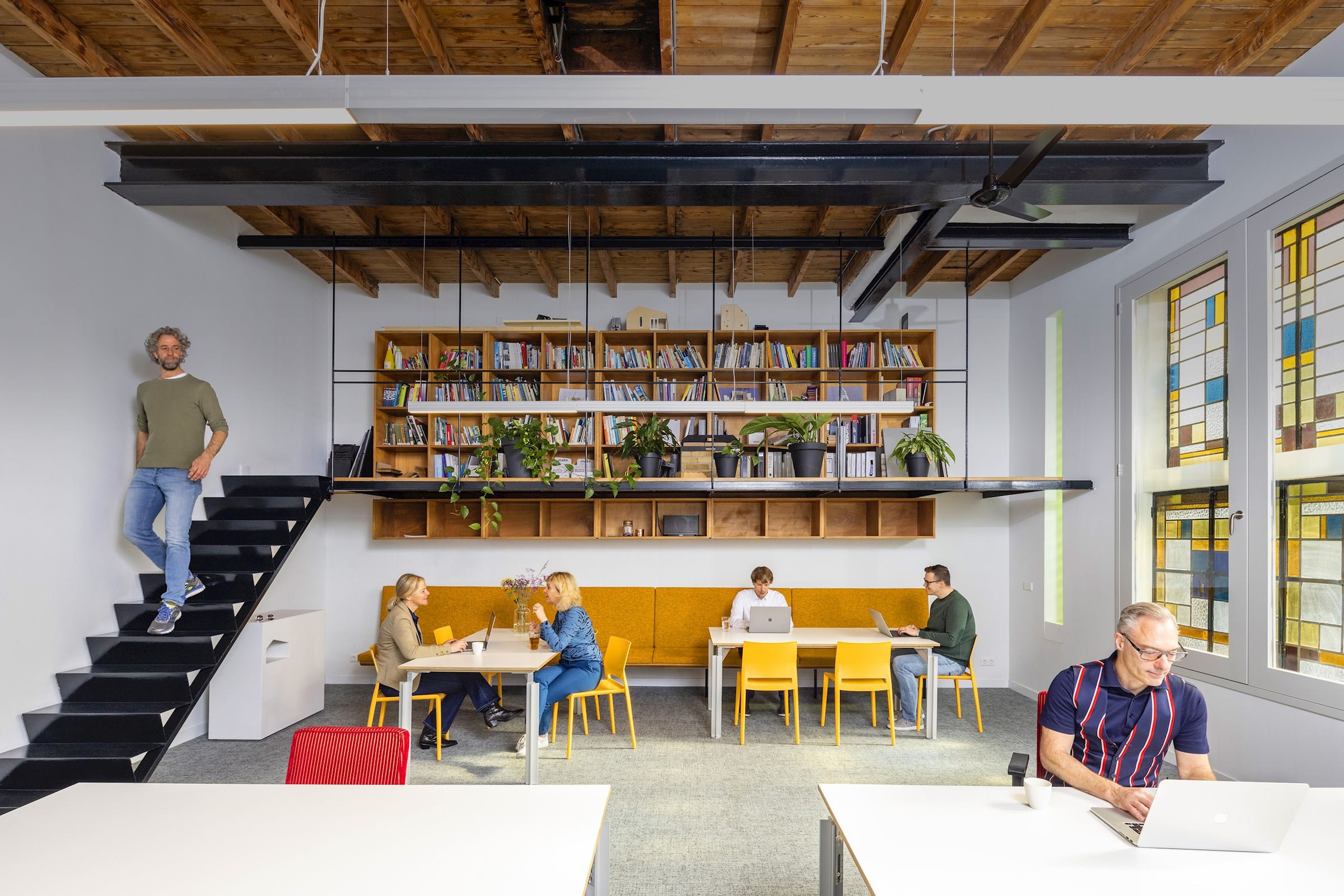The Schwung office in Tilburg: a bright loft with a bookcase, work tables and the team at work.